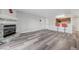 Cozy living room with wood flooring, fireplace, breakfast bar, and red bar stools at 2451 N Rainbow Blvd # 2144, Las Vegas, NV 89108