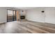 Open living room area has wood-look floors, fireplace and access to a balcony at 2451 N Rainbow Blvd # 2144, Las Vegas, NV 89108