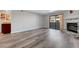 Open-concept living room with wood floors, fireplace, and access to the balcony at 2451 N Rainbow Blvd # 2144, Las Vegas, NV 89108