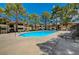 Inviting community pool with lounge chairs for sunbathing, surrounded by lush trees and well-maintained landscaping at 2451 N Rainbow Blvd # 2144, Las Vegas, NV 89108