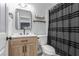 Bathroom featuring a vanity, framed mirror, and tiled shower with a dark shower curtain at 2451 Old Forge Ln # 105, Las Vegas, NV 89121