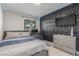 Bedroom featuring a decorative textured wall with TV, ceiling fan and desk at 2451 Old Forge Ln # 105, Las Vegas, NV 89121