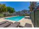 Relax by the community pool with lounge chairs and lush landscaping at 2451 Old Forge Ln # 105, Las Vegas, NV 89121
