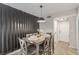 Elegant dining room with modern accent wall, stylish table setting, and wood laminate flooring at 2451 Old Forge Ln # 105, Las Vegas, NV 89121