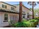 The front exterior of this two story unit features mature landscaping and a concrete path at 2451 Old Forge Ln # 105, Las Vegas, NV 89121