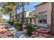 Charming townhomes feature well-maintained landscaping, mature trees, and inviting curb appeal at 2451 Old Forge Ln # 105, Las Vegas, NV 89121