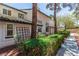 This two story exterior has trees in the front yard and dark trim around the roof at 2451 Old Forge Ln # 105, Las Vegas, NV 89121