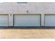 Three white garage doors are displayed, with the middle door being the largest at 2451 Old Forge Ln # 105, Las Vegas, NV 89121