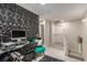 A second floor hallway shows a geometric accent wall, two white doors, and access to a bathroom at 2451 Old Forge Ln # 105, Las Vegas, NV 89121