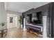 Bright living space with modern TV wall, open concept to the dining, and wood laminate flooring at 2451 Old Forge Ln # 105, Las Vegas, NV 89121