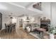 Bright open-concept living space with vaulted ceilings, modern fireplace, and laminate flooring at 2451 Old Forge Ln # 105, Las Vegas, NV 89121