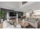 Spacious living room featuring open floor plan, sleek entertainment center, and modern decor at 2451 Old Forge Ln # 105, Las Vegas, NV 89121