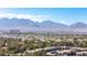 Expansive aerial shot showing community housing nestled against a mountain range at 2708 Norbeck St, Las Vegas, NV 89117