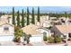 Aerial perspective showcasing a well-kept neighborhood with desert landscaping and stunning mountain views at 2708 Norbeck St, Las Vegas, NV 89117