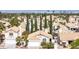High-angle view of a residential community with mature trees and a stunning backdrop of the city skyline at 2708 Norbeck St, Las Vegas, NV 89117