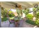 Back patio area with table and chairs, perfect for outdoor entertaining amidst lush landscaping at 2708 Norbeck St, Las Vegas, NV 89117