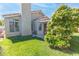Backyard with grassy lawn, mature trees, and covered patio, offering a peaceful outdoor space at 2708 Norbeck St, Las Vegas, NV 89117