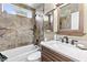 Charming bathroom with granite style tile walls and updated fixtures at 2708 Norbeck St, Las Vegas, NV 89117