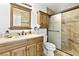 Well-lit bathroom with tiled shower and glass door, updated vanity, and modern fixtures at 2708 Norbeck St, Las Vegas, NV 89117