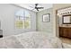 Bedroom with a large window, ceiling fan and ensuite bathroom access at 2708 Norbeck St, Las Vegas, NV 89117