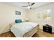 Comfortable bedroom features a ceiling fan, window and wood-look flooring at 2708 Norbeck St, Las Vegas, NV 89117