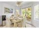 Bright dining area featuring tile flooring, stylish furnishings, and sliding door to patio at 2708 Norbeck St, Las Vegas, NV 89117