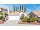 Charming single-story home features a desert landscape, tile roof, and attached garage at 2708 Norbeck St, Las Vegas, NV 89117