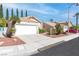 Inviting single-story home with a two-car garage, tiled roof, and desert-friendly landscaping at 2708 Norbeck St, Las Vegas, NV 89117