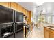 Bright kitchen features oak cabinets, tile flooring, and stainless steel appliances at 2708 Norbeck St, Las Vegas, NV 89117
