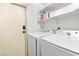 Laundry room with washer, dryer, overhead shelving, and a door at 2708 Norbeck St, Las Vegas, NV 89117