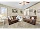 Spacious living room featuring neutral carpet, and classic furnishings with view to entry and dining area at 2708 Norbeck St, Las Vegas, NV 89117