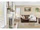 A well lit living room with a fireplace, a couch, and carpeted floors at 2708 Norbeck St, Las Vegas, NV 89117