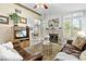 Bright living room featuring a fireplace, plantation shutters, and backyard views at 2708 Norbeck St, Las Vegas, NV 89117