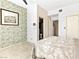 Bright main bedroom featuring patterned wallpaper, neutral carpet, a ceiling fan and ensuite access at 2708 Norbeck St, Las Vegas, NV 89117