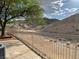 A scenic desert mountain view with trees, a fence, and desert landscaping at 3349 Partridge Run St, Laughlin, NV 89029