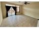 Spacious bedroom with neutral walls, tile floors, and a sliding glass door to the patio at 3349 Partridge Run St, Laughlin, NV 89029