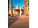 Charming community clubhouse entrance with palm trees, offering a welcoming gathering place at 3349 Partridge Run St, Laughlin, NV 89029