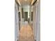 Hallway with tile floors and mirrored closet doors, leading to the bathroom at 3349 Partridge Run St, Laughlin, NV 89029