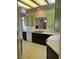Functional kitchen with tile floors, neutral counters, modern appliances, and green cabinets at 3349 Partridge Run St, Laughlin, NV 89029
