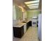 Functional kitchen with tile floors, neutral counters, modern appliances, and green cabinets at 3349 Partridge Run St, Laughlin, NV 89029
