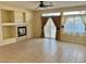 Spacious living room features tile flooring, fireplace, and large windows with curtains at 3349 Partridge Run St, Laughlin, NV 89029