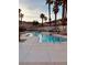 A beautiful view of the neighborhood pool area with many palm trees at 3349 Partridge Run St, Laughlin, NV 89029