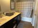 Bright bathroom featuring a double vanity and shower with striped curtain at 3400 Denali Preserve St, Las Vegas, NV 89122