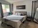 Comfortable bedroom featuring a cozy bed, soft lighting, and gray curtains at 3400 Denali Preserve St, Las Vegas, NV 89122