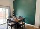 Charming dining area with a wooden table, black chairs, and sliding glass doors at 3400 Denali Preserve St, Las Vegas, NV 89122