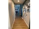 Hallway with wood-look floors and decor leading to dining area at 3400 Denali Preserve St, Las Vegas, NV 89122