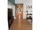 Long hallway with wood-look floors and a bright white front door at 3400 Denali Preserve St, Las Vegas, NV 89122
