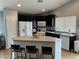 Stylish kitchen with granite countertops, island seating, and stainless steel appliances at 3400 Denali Preserve St, Las Vegas, NV 89122