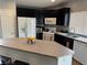 Stylish kitchen with granite countertops, island seating, and stainless steel appliances at 3400 Denali Preserve St, Las Vegas, NV 89122