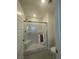 Bright modern shower with glass door and white tile at 3534 Alpheus River Ave, Las Vegas, NV 89106